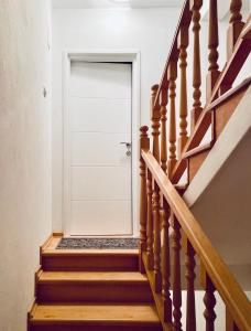 a stairway with a white door in a house at Komiza Provita Guesthouse in Komiža