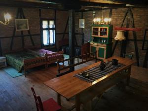 a living room with a wooden table and a stove at Etno Kuća - Rakić in Svrljig