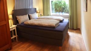 a bed with two pillows on it in a room at Immenhof in Flensburg
