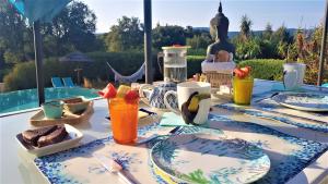 a table with plates of food and drinks on it at Villa des Delices in Grimaud