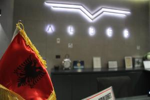 a red flag is hanging in a waiting room at Albes Hotel in Fier