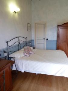 a bedroom with two beds and a dresser at La Locanda di San Biagio in Bolzaneto