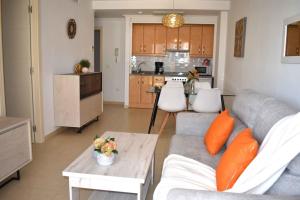 a living room with a couch and a table and a kitchen at ROCASOL - Beach in Calpe