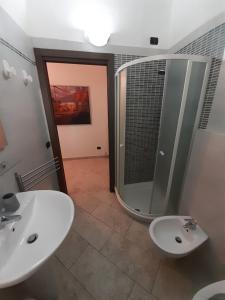 a bathroom with two sinks and a large mirror at Parma Holiday 2020+21 in Parma