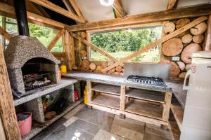 a kitchen with a stove and an oven in a cabin at Camping & Glamping Jezersko ex Cvet Gora in Zgornje Jezersko