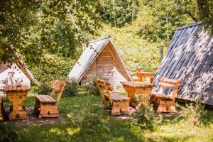 a group of chairs and a table and a cabin at Cvet gora - Camping, Glamping and Accomodations in Zgornje Jezersko