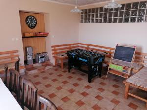 a room with a stove and a table and chairs at Apartment House Koprivnik in Zreče