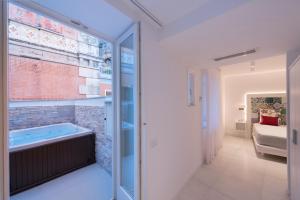 a bathroom with a hot tub in a brick wall at Amalfi Suite Boutique Hotel in Amalfi