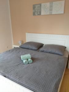 a bed with two rolled up towels on it at Zámecký apartmán v Horní Plané in Horní Planá