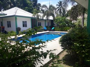 a swimming pool in front of a house at Sunya Cottage in Lamai