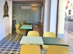 eine Reihe von Tischen und gelben Stühlen in einem Zimmer in der Unterkunft Hotel 19-30 Valencia in Valencia