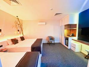 a hotel room with a bed and a tv at Luis Otel in İzmir