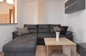 a living room with a couch and a table at Apartments Milena 436 in Fažana