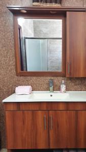 a bathroom with a sink and a mirror at Martini Dead Sea in Neve Zohar