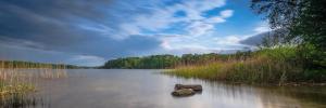 a lake with a rock in the middle of it at Extravagantes Apartment in Potsdam