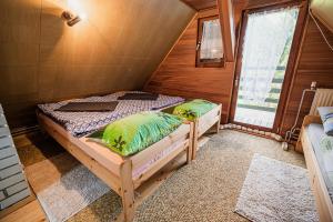 a bedroom with a bed in a wooden cabin at Cottage Hidden Pearl in Zgornje Jezersko
