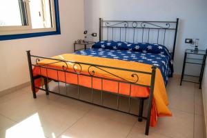 a bedroom with a bed with an orange blanket at Taormina Isola bella suite in Taormina