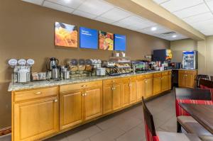 a restaurant with a counter with food on it at Comfort Inn in Waynesboro