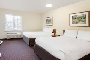 Katil atau katil-katil dalam bilik di WoodSpring Suites Tyler Rose Garden