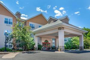 a building with a gazebo in front of it at Comfort Suites in Marquette