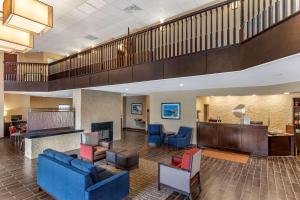 a lobby of a hospital with blue couches and chairs at Comfort Suites near Camp Lejeune in Jacksonville