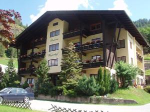 un edificio con un coche aparcado delante de él en Pension Trojerhof, en Heiligenblut