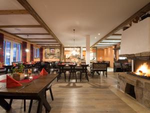 a large room with tables and chairs and a fireplace at Landgasthof Schwarzes Roß in Ansbach