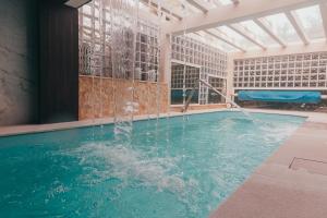 a swimming pool with a fountain in a building at Joy Beach House in São Pedro de Moel