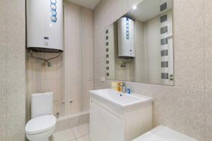 a bathroom with a toilet and a sink and a mirror at Lux Most City Area, Panoramic city View in Dnipro