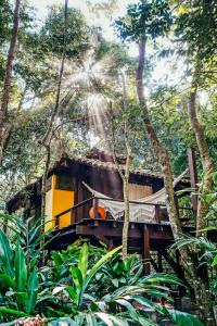 a train in the jungle with trees in the background at Canto Leela Eco Bungalows in Serra Grande