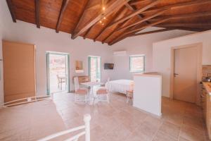 a large room with a bed and a table and chairs at George SeaFront Suites in Neon Oitilon