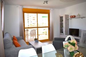 a living room with two couches and a table at ROCASOL - Beach in Calpe