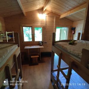 a room with two bunk beds in a cabin at Bike Camping in Przewóz