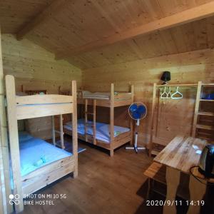 a room with two bunk beds in a cabin at Bike Camping in Przewóz
