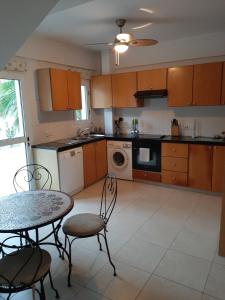 a kitchen with a table and chairs and a sink at Drouseia Villa in Droushia