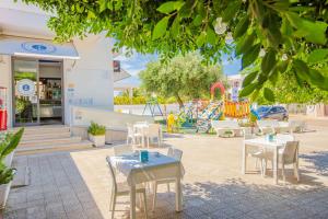 a park with tables and chairs and a playground at Villa Orchidea in Torre Santa Sabina