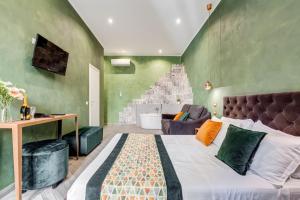 a bedroom with a bed and a green wall at Ripetta Deluxe Suites in Rome