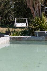 un banco blanco sentado junto a una piscina en O Sequeiro en Vila Nova de Famalicão