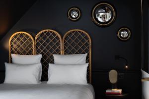 a bedroom with a bed with two white pillows at Chouchou Hotel in Paris
