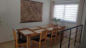 einen Holztisch und Stühle im Esszimmer in der Unterkunft Casa Roca in Caleta de Fuste