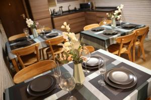 a dining room with a table with plates and glasses at Bienestar House in Blanes