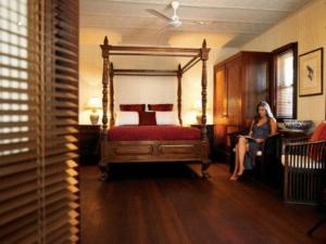
a bedroom with a large bed and a large window at Pinctada McAlpine House in Broome

