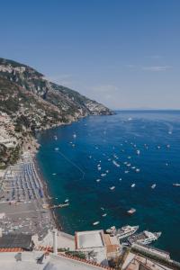 an aerial view of a beach with boats in the water at Villa Nettuno in Positano