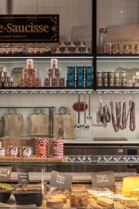 a display case in a bakery with food on display at Chouchou Hotel in Paris