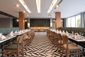 a dining room with long tables and chairs at Green Garden Resort & Spa Hotel in Alanya