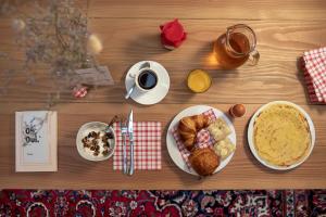 a table with a plate of food and a cup of coffee at Chouchou Hotel in Paris