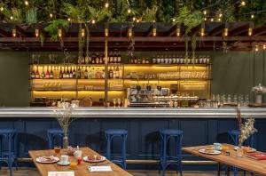 a restaurant with two tables and a bar at Chouchou Hotel in Paris