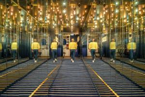 a group of men walking through a room with lights at Chouchou Hotel in Paris +37 photos