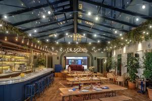a restaurant with wooden tables and a bar at Chouchou Hotel in Paris