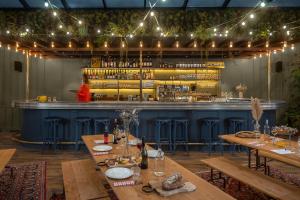 a restaurant with wooden tables and a bar at Chouchou Hotel in Paris